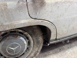 a dirty car that is parked on the side of the road