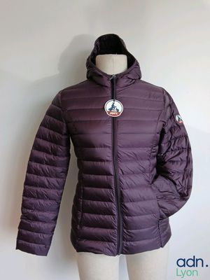 the jacket is purple and has a badge on it
