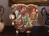 three vases sitting on a table next to a painting