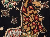 a picture of a black rug with a picture of a giraffe on it