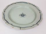 a blue and white plate with a flower design on it