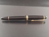 a pen sitting on a table with a reflection on it