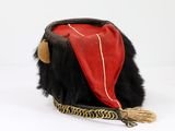 a black and red bag with a red scarf on it