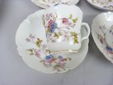 four tea cups and saucers on a table