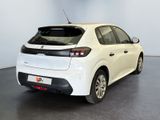 the back of a white car in a room with a black floor