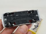a person holding a small toy car in their hand