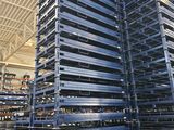 several pallets stacked up in a warehouse with a ceiling in the background