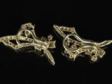 a pair of gold tone cufflinks with a stylized design