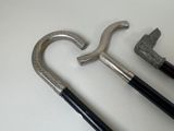 two old canes and a hammer on a table