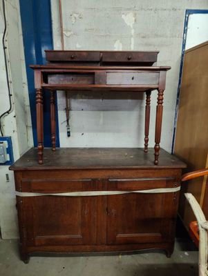 a dresser and a bed in a room with a blue door