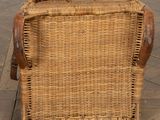 a wicker chair sitting on a wooden floor