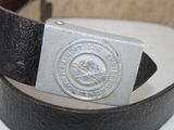 a belt that has a silver buckle on it