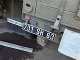 a military truck that is parked on the side of the road