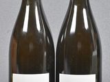two bottles of wine sitting next to each other on a table