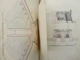 an open book with drawings of a building and a clock tower