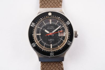 a watch that is sitting on a white surface