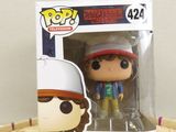 a close up of a pop vinyl figure in a box on a table