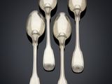 three silver spoons and a spoon rest on a black surface