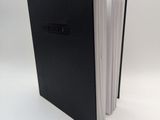 the black book is open on a white surface