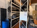 many tires stacked on the shelves in the garage