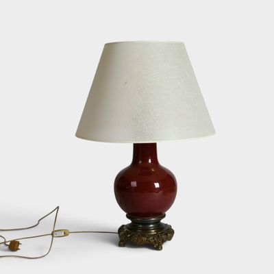 an image of a red lamp with a white shade on it