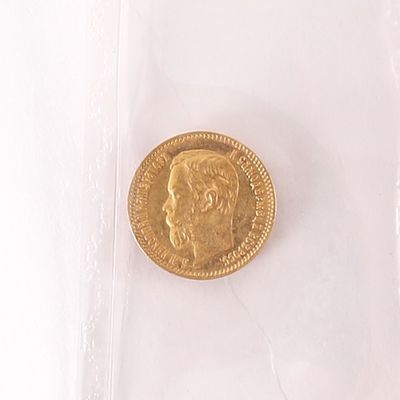 une pièce d'or sur laquelle figure l'image d'un homme