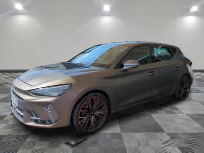 a grey car is parked in a room with a checkered floor