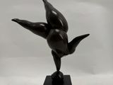 bronze sculpture of a bird on a black marble base