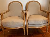 two chairs sitting next to each other on a wooden floor