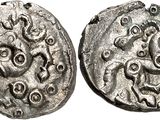 a silver coin with an image of a horse on it