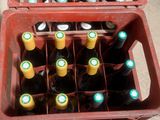 many bottles of beer in a red crate on the floor