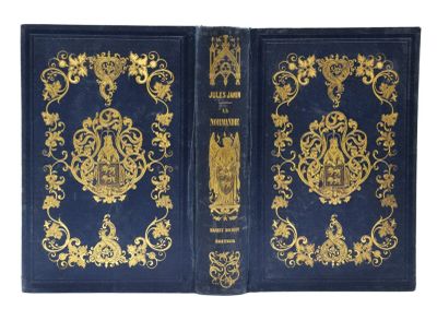 un vieux livre bleu avec des motifs dorés sur la couverture