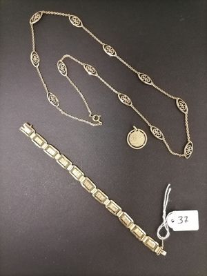 a close up of a necklace and a bracelet on a table
