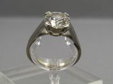 an image of a diamond ring on a clear stand