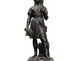 bronze statue of a woman holding a basket and a dog