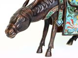 a figurine of a horse with a saddle on it ' s back