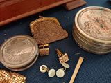 a lot of jewelry on the floor next to a dresser