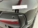a car that has a sticker on the back of it ' s bumper