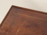 a close up of a wooden table with a clock on it
