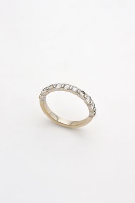 a close up of a diamond ring on a white surface