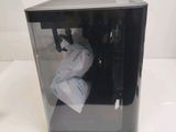 a black box with a bag of toilet paper inside of it