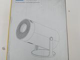 the box is open on a white table with a black and white drawing of a camera