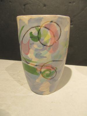 a cup with a design on it sitting on a table