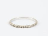 a white gold wedding band with small diamonds