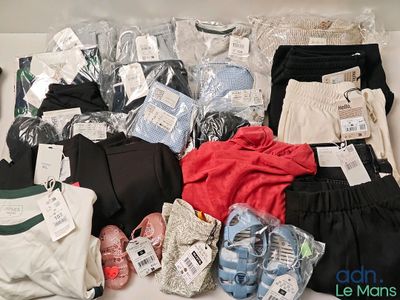 a pile of clothes and other items on a table