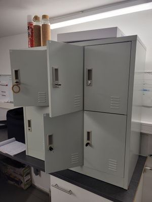 three metal lockers stacked on top of each other in a room