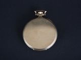an image of a silver pocket watch on a black background