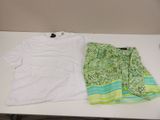 a white t - shirt and green shorts on a table