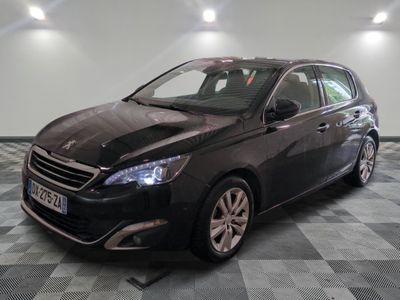 the black car is parked on a checkered floor in the garage