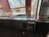 an image of a commercial kitchen with stainless steel counter tops